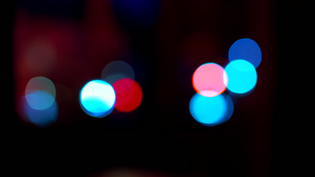 Abstract display of out-of-focus, colourful lights in a dark setting