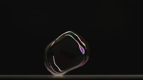 the two soap bubbles connecting in one. slow motion