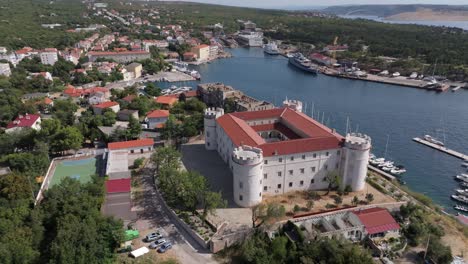 aerial view of a coastal town with a castle and harbor