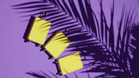 Suitcases-on-tropical-purple-background-vertical