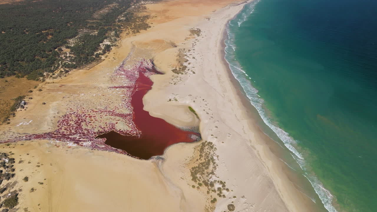 Aerial View Of Salt Flat WIth Red Water By The Beach In Socotra Island, Yemen