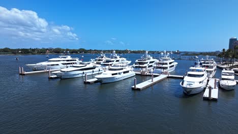 low orbit drone shot of white yachts in west palm beach marina during the day in florida, usa