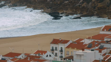 ocean coast with houses and rocks in nazare portugal