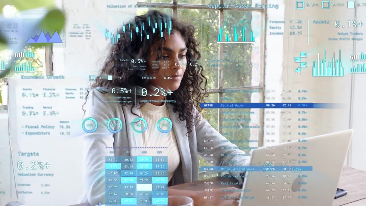 Woman focusing on laptop and reviewing animated tech charts, pausing to sip mug, resuming typing