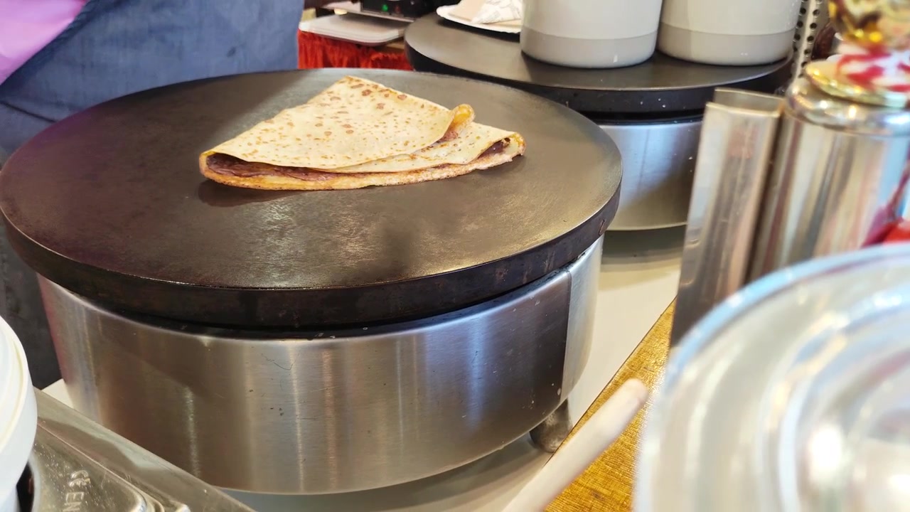 Street food vendor preparing fresh crepe