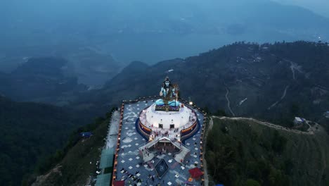 Aerial-tilt-up-reverse-dolly-of-lord-shiva-statue-in-pumdikot-nepal