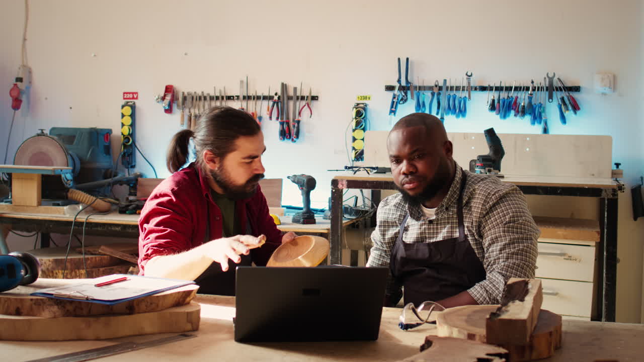 Team of manufacturers discussing furniture assembly schematics