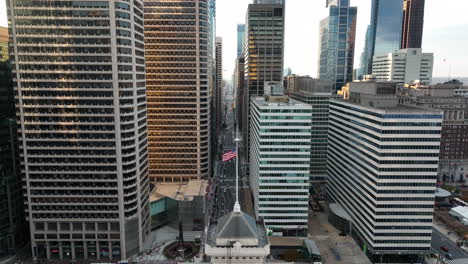 aerial of american flag in downtown urban city in usa