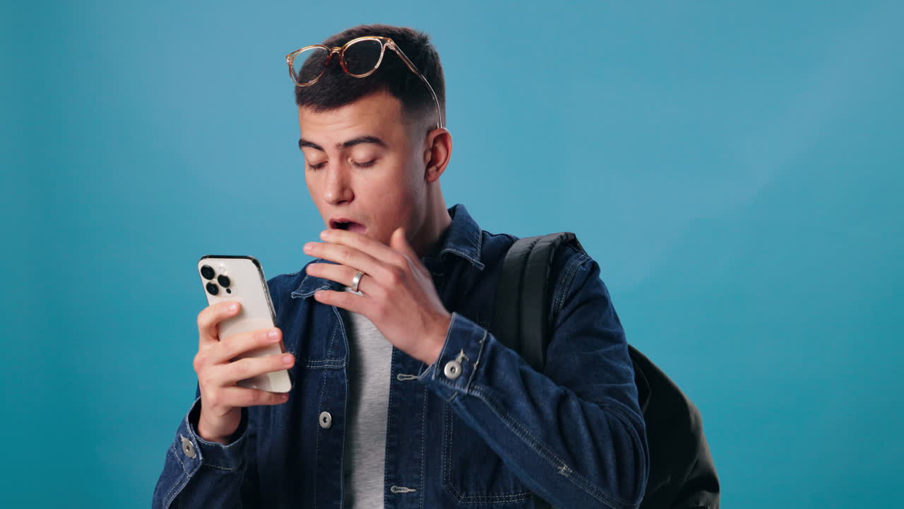 Surprised man looking at his mobile phone