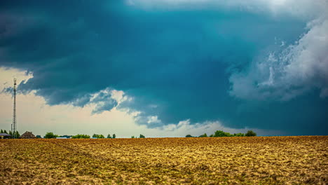 tiemlapse of expanding dark clouds formation over a countryside in latvia