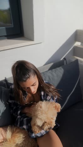 woman cuddling with a poodle