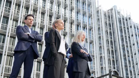 business professionals standing outside a modern corporate building