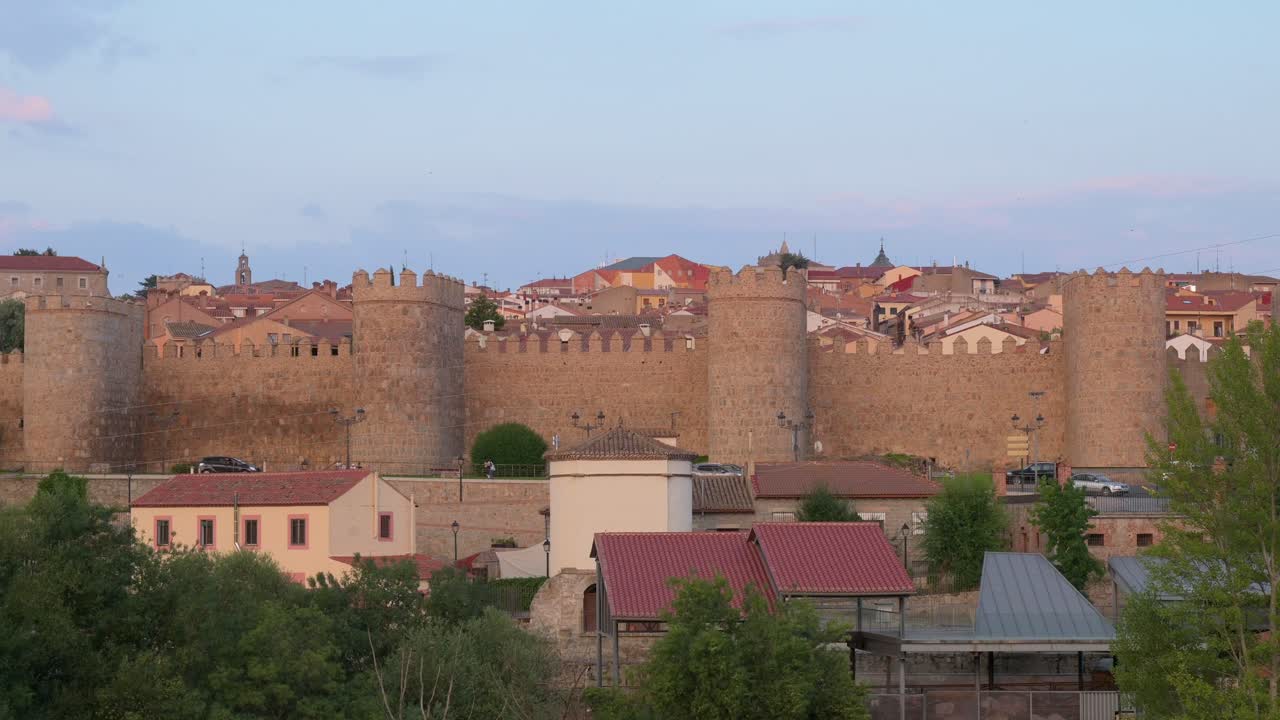 View of Avila during the golden hours of sunset, featuring the old town and its medieval walls, a UNESCO World Heritage Site.