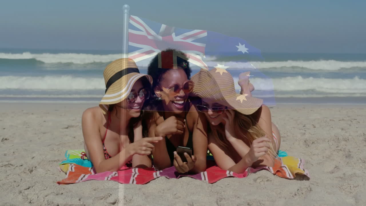 Wearing sun hats, three women on beach with Australian flag animation overlay