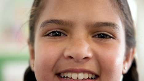 smiling girl in school, close-up of joyful expression and bright eyes