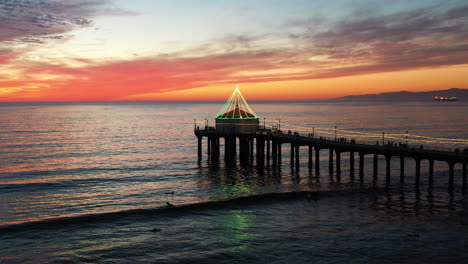 Aerial-landscape-view-of-Manhattan-Beach-Pier-silhouette,-California,-at-sunset