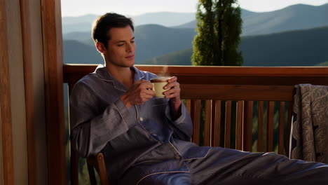 man relaxing outdoors with coffee