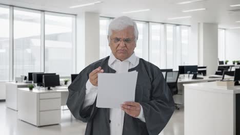 confused indian senior lawyer reading court case papers