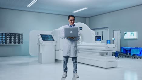 full body of asian male doctor typing on a laptop and smiling with mri machine in the hospital