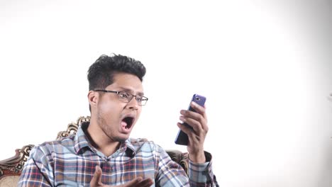 hombre mirando su teléfono con una expresión de sorpresa o preocupación