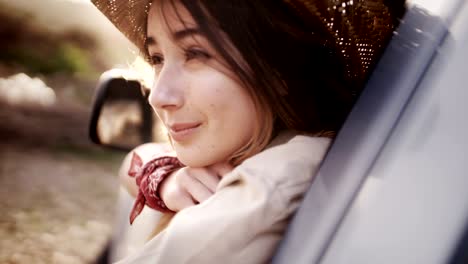 beautiful young country woman looking out of a pick-up truck