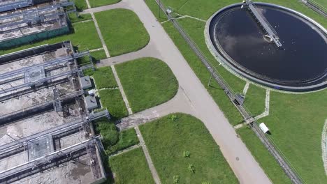 sewage farm. static aerial photo looking down onto the clarifying tanks and green grass.