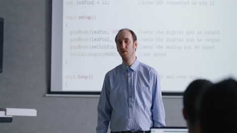 teacher presenting coding concepts in a classroom