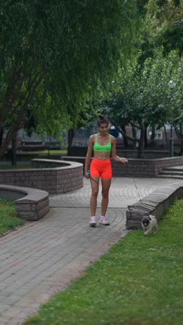 woman walking her pug in a park