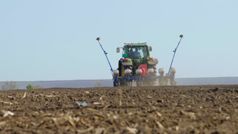 tractor planting crops in a field