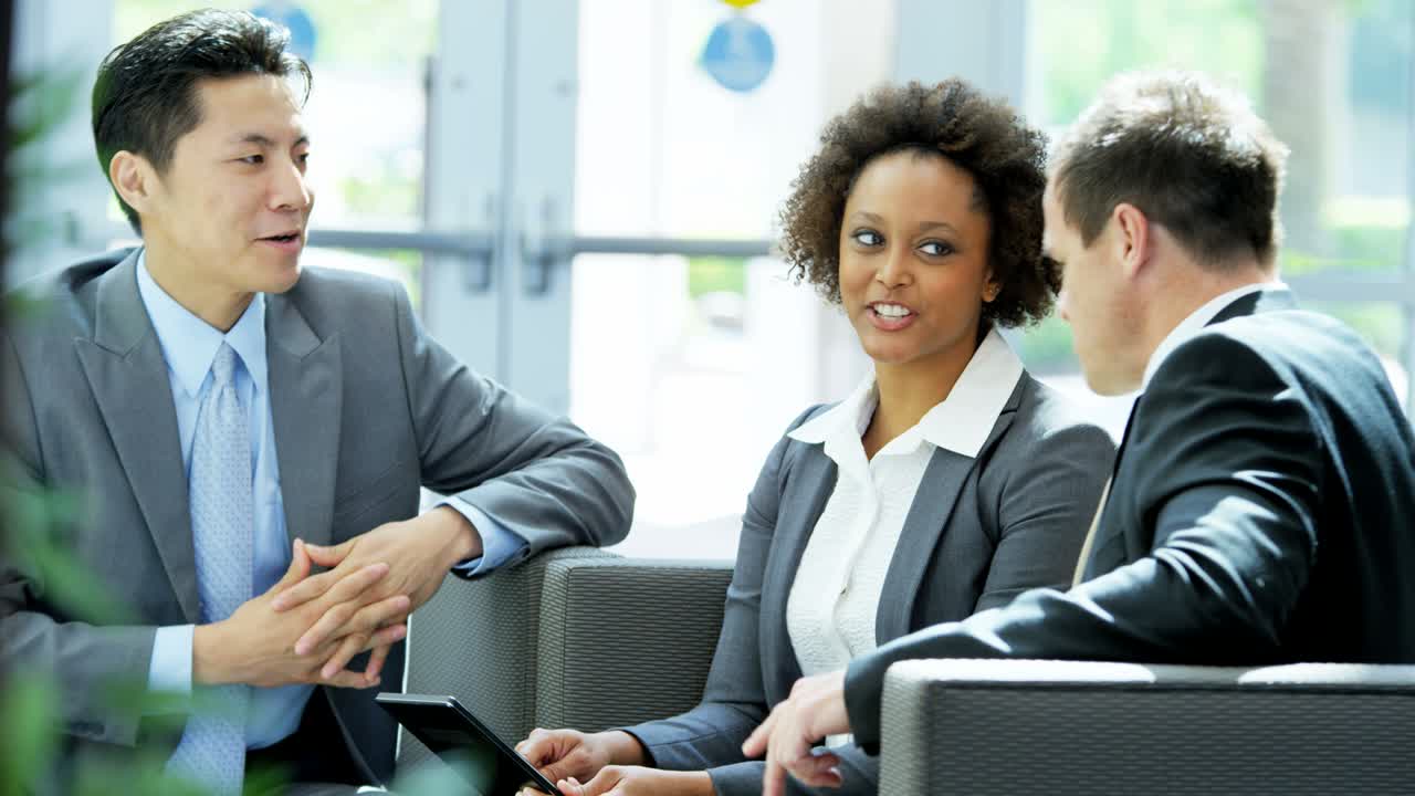 Multi ethnic business consultants meeting using tablet technology