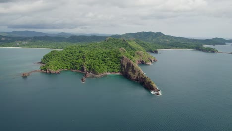 A-4K-drone-shot-of-Punta-Sabana-Point-and-the-Mirador-Conchal-Peninsula-next-to-Puerto-Viejo-and-Playa-Conchal,-or-“Shell-Beach”,-along-the-north-western-coast-of-Costa-Rica