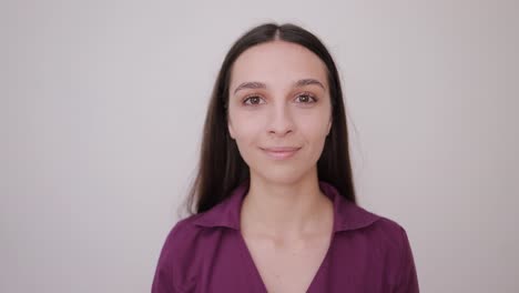 carefree woman with long dark hair gracefully poses calmly on a subtle neutral background a serene woman with long dark hair gracefully poses in a calm manner against a subtle neutral backdrop