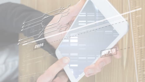 animation of graphs with changing years, circuit board pattern over cropped hands using cellphone