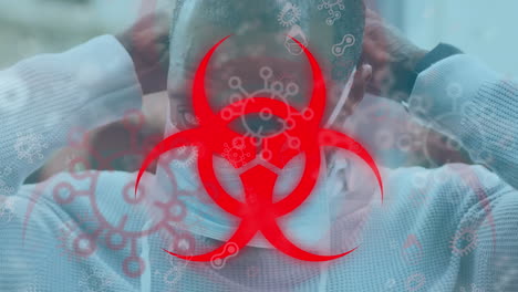 animation of biohazard sign and virus cells over man wearing face mask