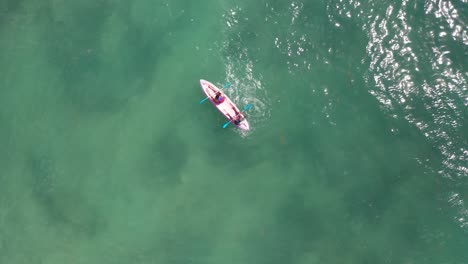 peoples are kayaking in middle of ocean