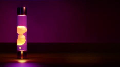 yellow lava lamp on dark background with empty place - loop video