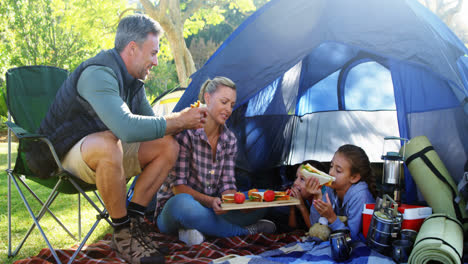 Family-having-snacks-outside-the-tent