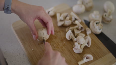 shot from above of chef slicing mushrooms