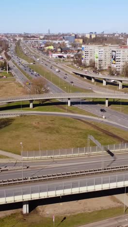 vertical aerial drone shot of busy intersection and traffic in riga, latvia