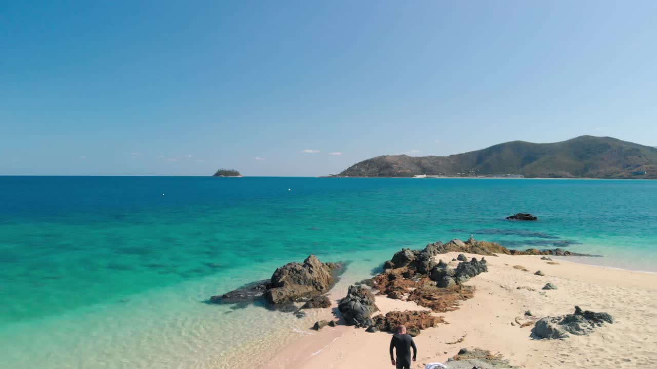 Revealing cinematic drone 4K shot  aerial forward tracking low angle motion over the white sands of Hill Inlet at Whitehaven Beach, Whitsundday Islands, Queensland, Australia