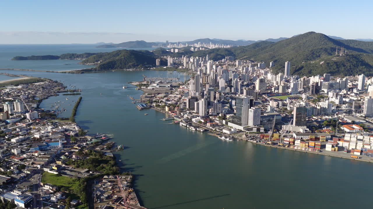 Sunny aerial cityscape of Itajaí with the Itajaí-Açu River and ferry connecting to Navegantes, Santa Catarina, Brazil