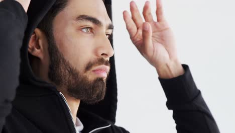 man in hoodie posing against white background 4k