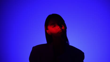 mysterious person in dramatic blue and red lighting effect a person is captured in dramatic lighting featuring vivid blue and red shadows creating a mysterious and intriguing visual effect
