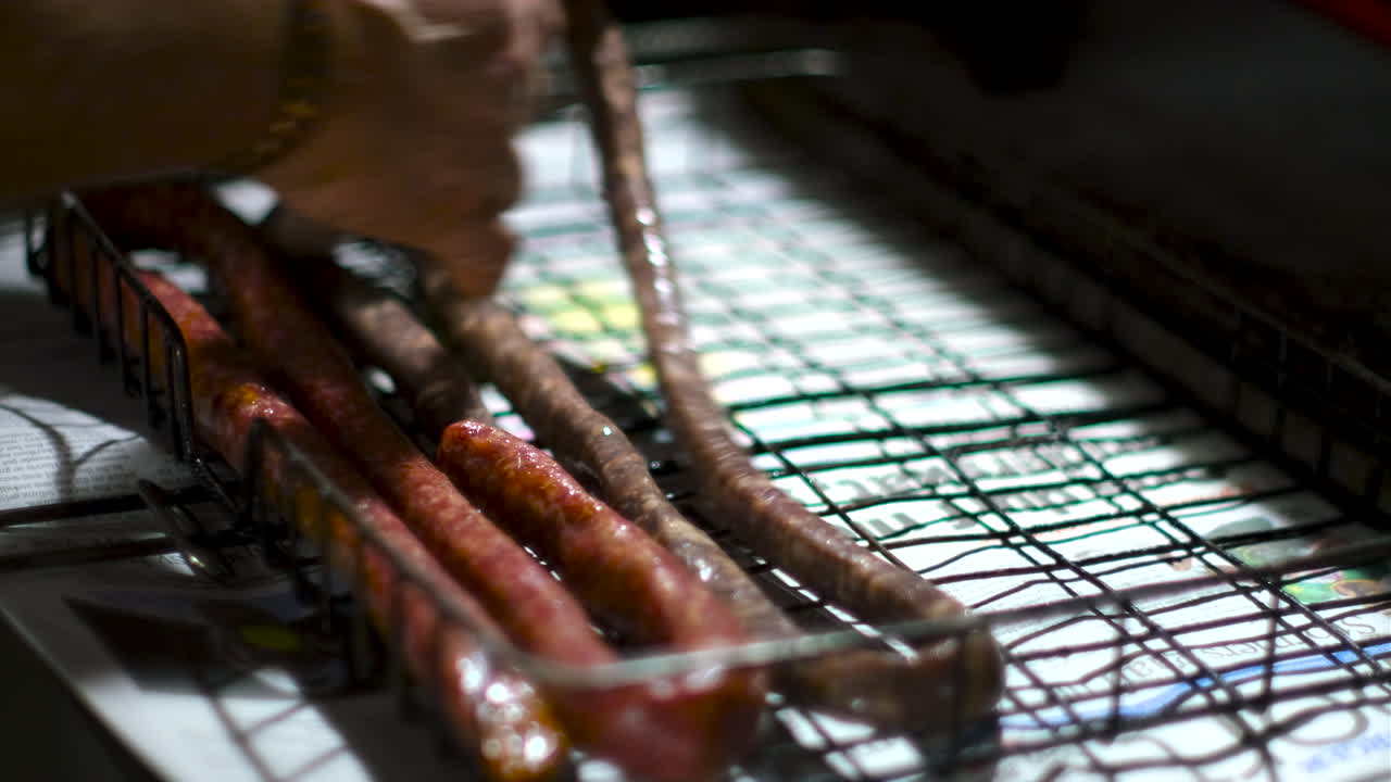 Traditional South African sausage placed on grid to be barbecued on coal fire