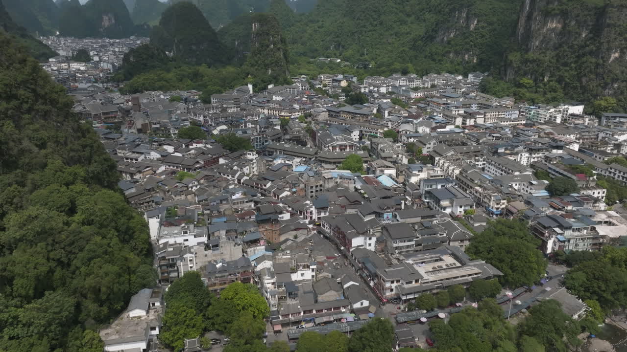 Aerial View of a Chinese Town Nestled Among Karst Mountains