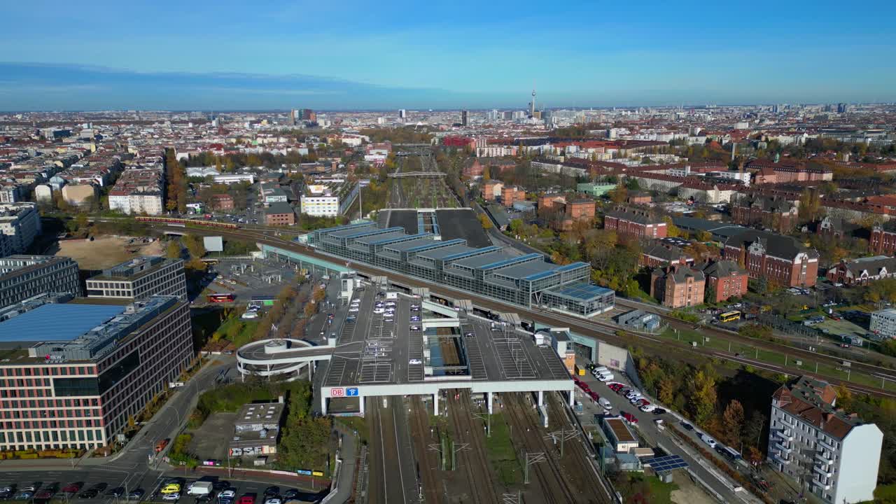Berlin cityscape with a modern train station South Cross and extensive railway lines under a clear sky. Magic aerial view flight fly push forward drone