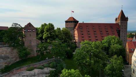 4k aerial drone video of the heidenturm heathens' tower and fünfeckturm five-cornered tower on the imperial castle in downtown nurnberg, germany