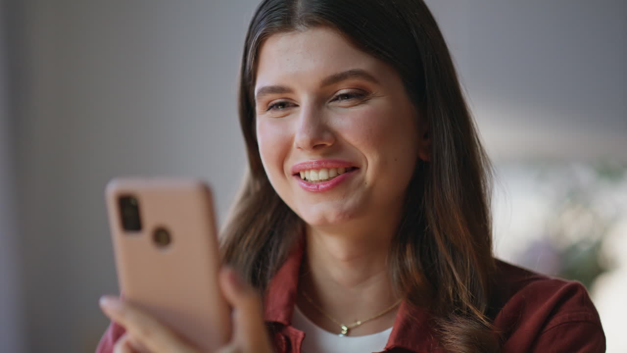 Woman finger tapping cellphone screen at home closeup. Brunette opening message