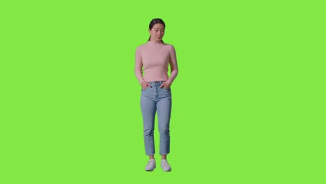 full length studio portrait of confident independent woman standing against green screen 1