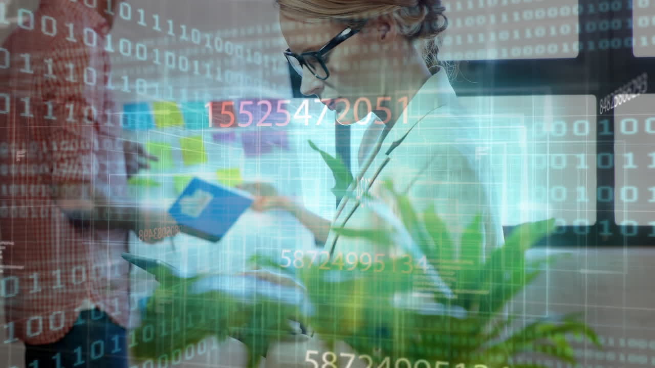 Female coworker writing on tablet in tech office, showing binary code streams and sticky notes